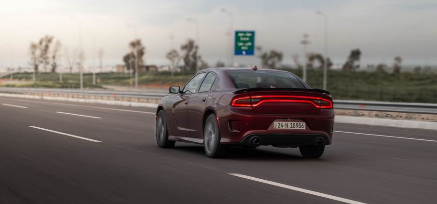 Car driving on an open highway — two-wheeler, car and commercial vehicle cover